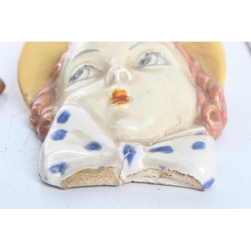 76 - A pair of small ceramic wall masks (a/f), largest 10cm.