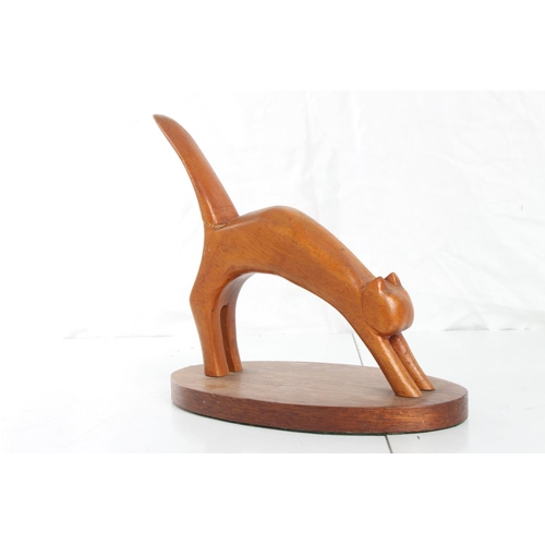 84 - A hand carved wooden cat figure.