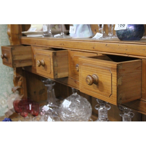 154 - A large modern pine dresser with decorative carved detail, measuring 53x20x48inches.