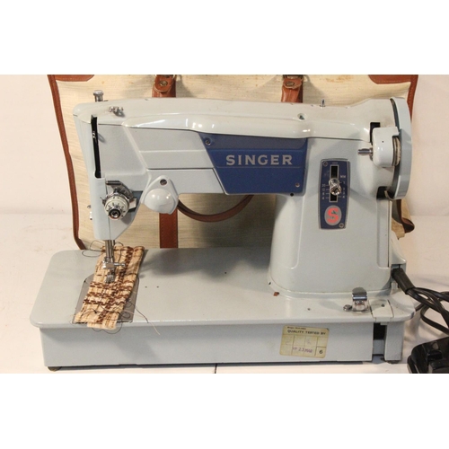 204 - A vintage Singer Sewing machine and bag/case.