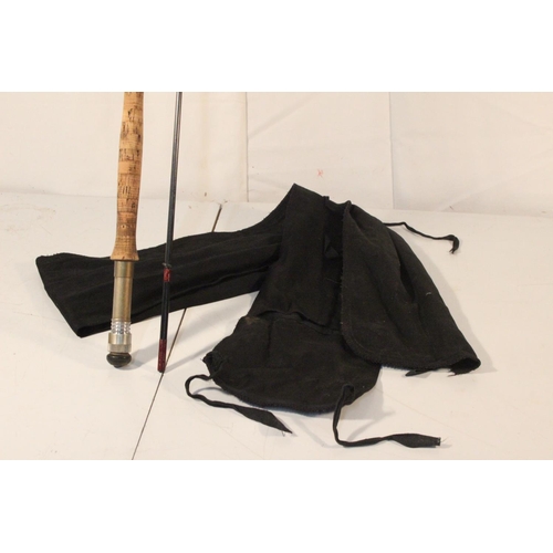 209 - A two piece fishing rod and bag.