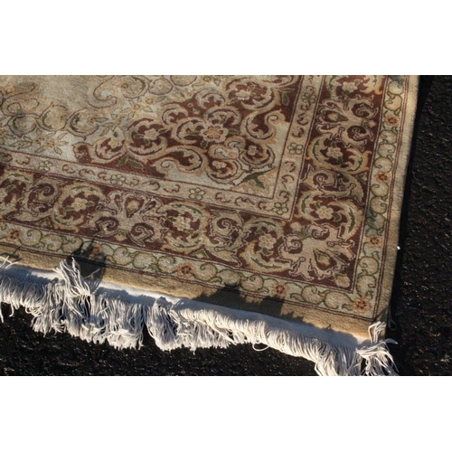 212 - A large patterned floor rug, measuring 180cm x 270cm.