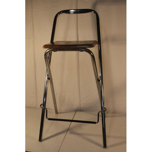 221 - A folding metal framed bar stool.