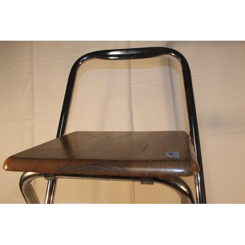 221 - A folding metal framed bar stool.