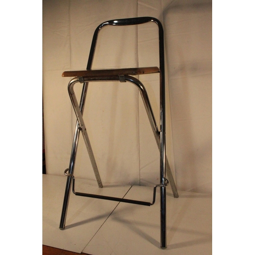 221 - A folding metal framed bar stool.