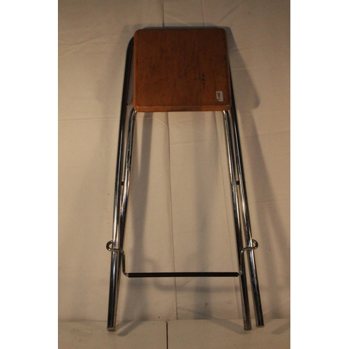 221 - A folding metal framed bar stool.