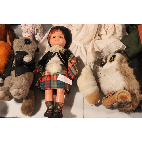 233 - A large lot of assorted soft toys and dolls.