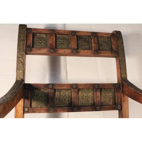 234 - A wooden chair  with metal work detail.