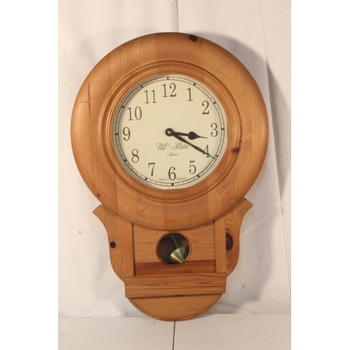 272 - A pine framed William Stinton wall clock.