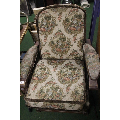 412 - A vintage upholstered armchair.