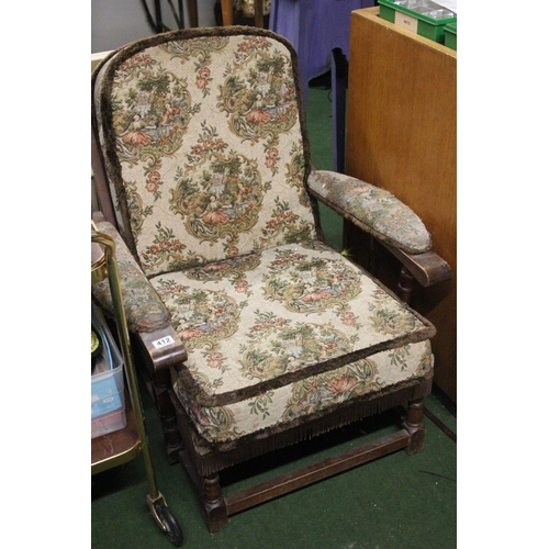 412 - A vintage upholstered armchair.