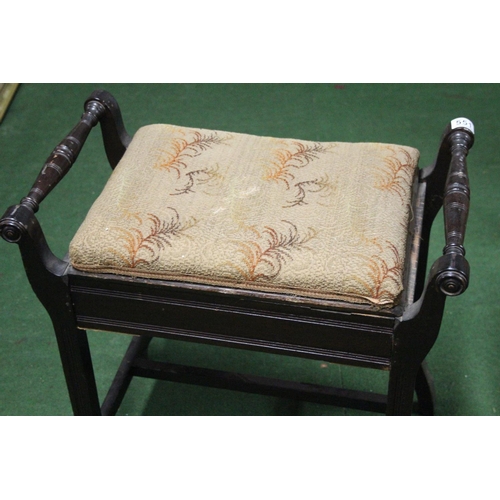 551 - An upholstered piano stool.