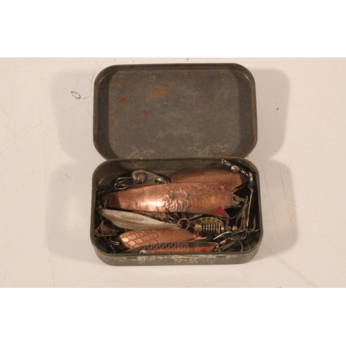 554 - A tin box of fishing lures.