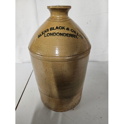 11 - A large antique stoneware whiskey flagon, 'Alexander Black & Co Ltd - Londonderry', measuring 45cm t... 