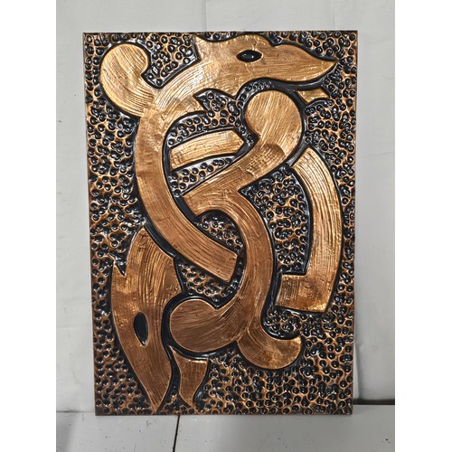 78 - A large beaten copper panel with Celtic design, measuring 38x55cm.