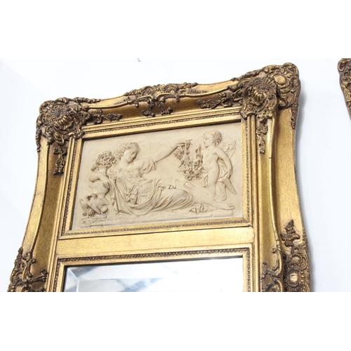 215 - A pair of large gilt framed mirrors with inset carved panels, bevelled glass & seals to rear. Each m... 