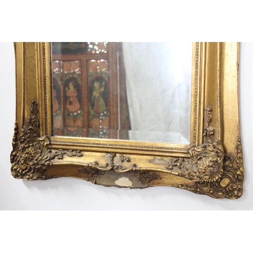 215 - A pair of large gilt framed mirrors with inset carved panels, bevelled glass & seals to rear. Each m... 