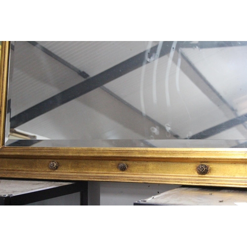 220 - A large antique style over mantle mirror with carved frame, bevelled glass mirror & decorative panel... 