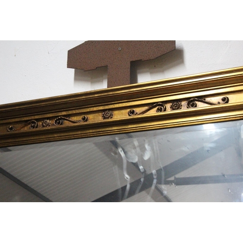 220 - A large antique style over mantle mirror with carved frame, bevelled glass mirror & decorative panel... 