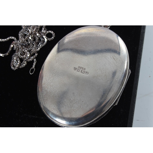 221 - A large sterling silver locket & chain.