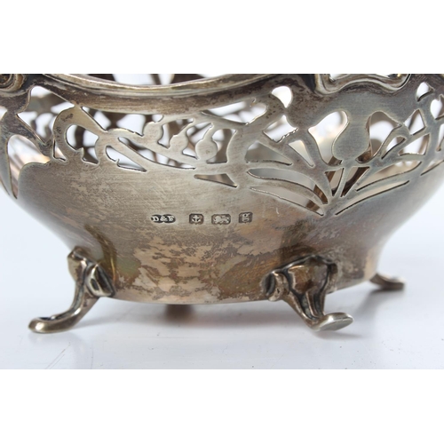 222 - A stunning antique sterling silver pierced basket with swing handle.