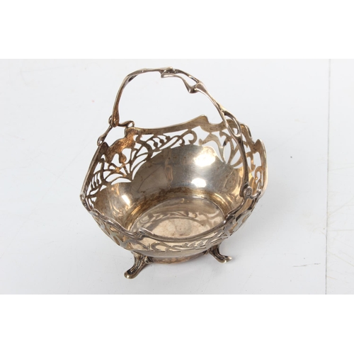 222 - A stunning antique sterling silver pierced basket with swing handle.