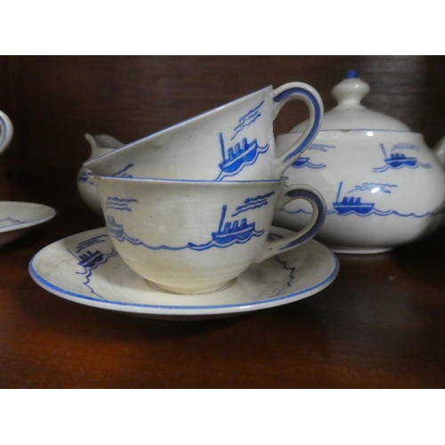 302 - A vintage child's tea set, with ship design, to include teapot, milk jug, 3 saucers & 6 cups.