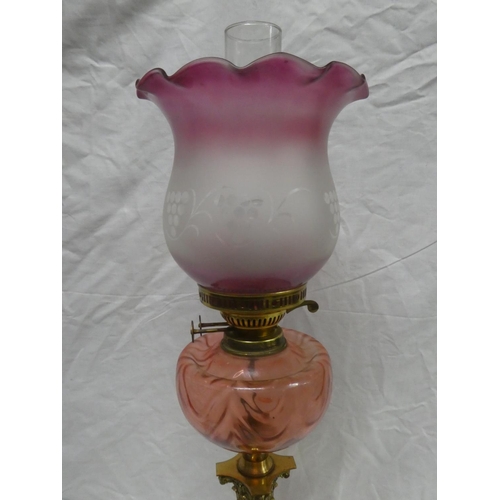 311 - A reproduction oil lamp table lamp, with brass Corinthian pillar base, ruby glass font & decorative ... 