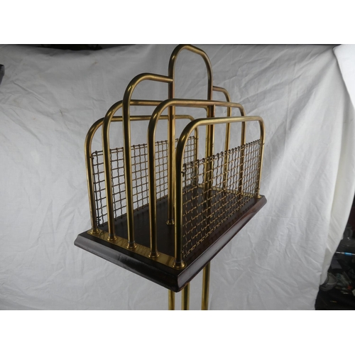 327 - An antique/ Edwardian oak & brass rotating magazine rack on tripod base.