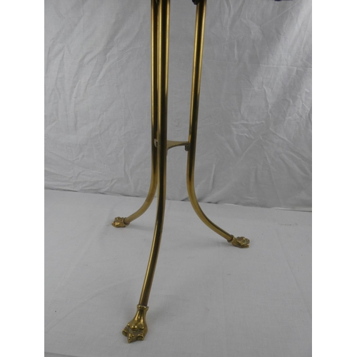 327 - An antique/ Edwardian oak & brass rotating magazine rack on tripod base.