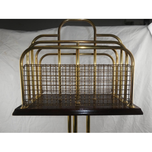 327 - An antique/ Edwardian oak & brass rotating magazine rack on tripod base.