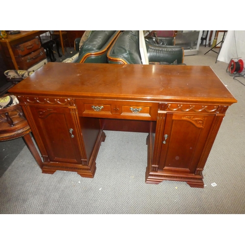 338 - A large modern office desk with carved panels. Measuring approx 52x21x31inches.