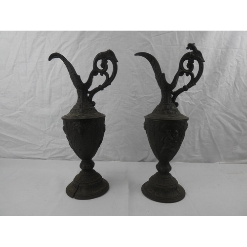 339 - A pair of decorative lead jugs, 1 in need of restoration, each measuring