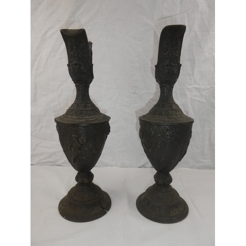 339 - A pair of decorative lead jugs, 1 in need of restoration, each measuring