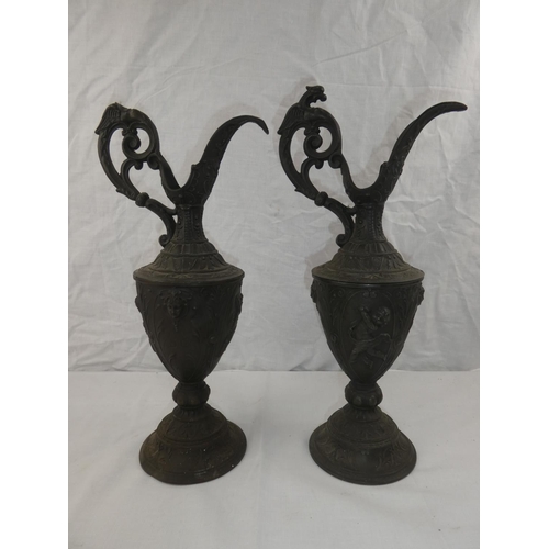 339 - A pair of decorative lead jugs, 1 in need of restoration, each measuring