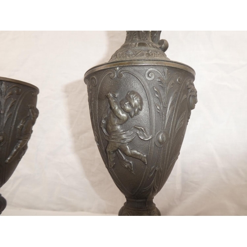 339 - A pair of decorative lead jugs, 1 in need of restoration, each measuring