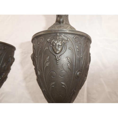 339 - A pair of decorative lead jugs, 1 in need of restoration, each measuring