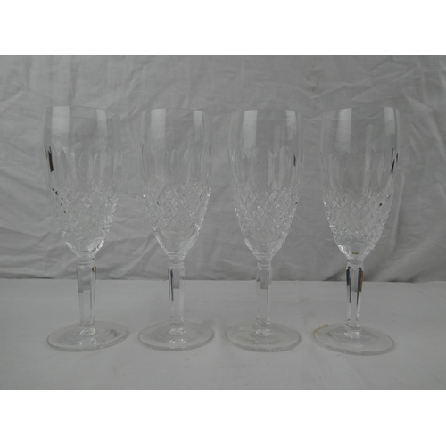 340 - A set of 4 Waterford Crystal champagne flutes.