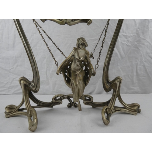 356 - A decorative antique/ Art Nouveau style dressing table mirror, with swinging figure.