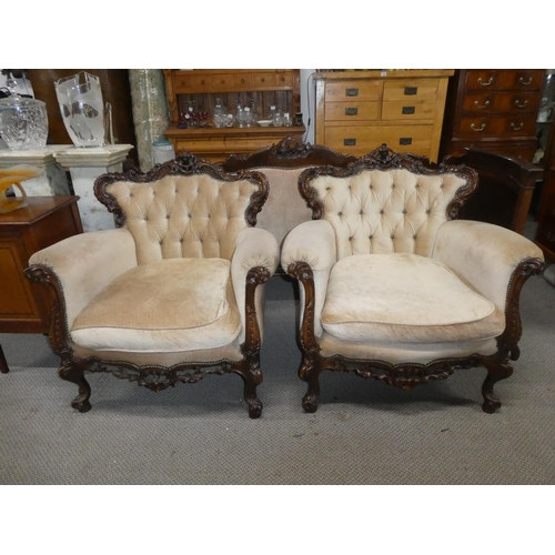 362 - A stunning antique style pair of armchairs with button back upholstery & decoratively carved frames.