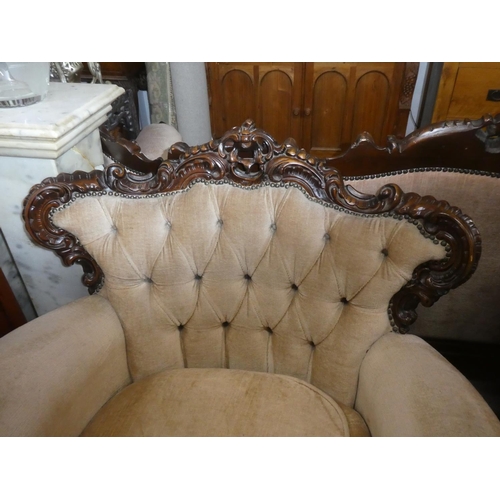 362 - A stunning antique style pair of armchairs with button back upholstery & decoratively carved frames.