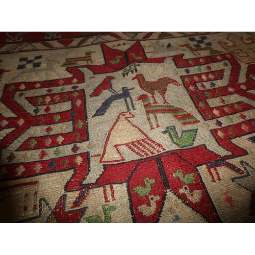 363 - A handwoven Iranian rug, decorated with various animals. Measuring 4ft x 5ft.