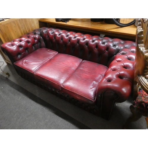 409 - A 3 seater red leather Chesterfield club sofa.