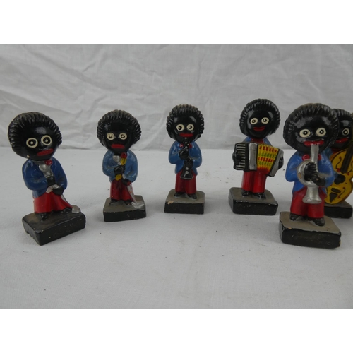 424 - A collection of 9 vintage hand painted Robinsons marmalade advertising figures.