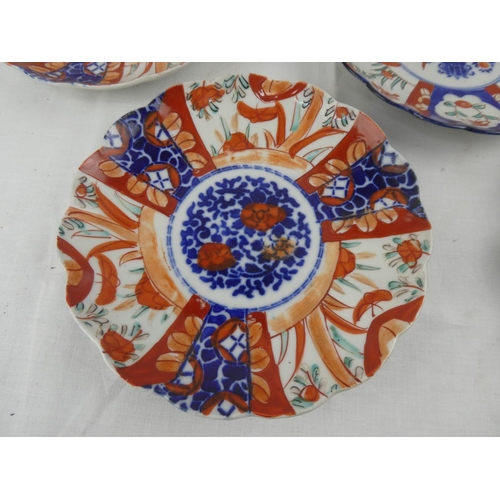 429 - A set of 3 antique hand painted Imari plates, along with similar piece.