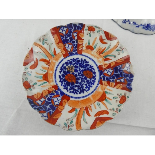 429 - A set of 3 antique hand painted Imari plates, along with similar piece.