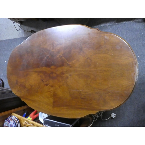 450 - A large vintage coffee table on brass lion paw feet. Measuring approx 51x31x22.5inches.