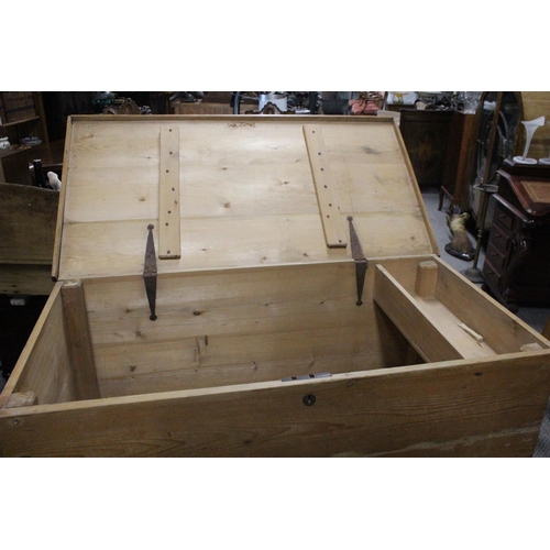 464 - A large antique Irish pine storage trunk/ blanket box. Measuring approx 49x26x32.5inches.