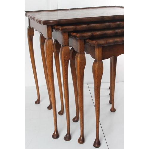 469 - A stunning antique nest of 4 walnut tables, with decorative edges, on cabriole legs.