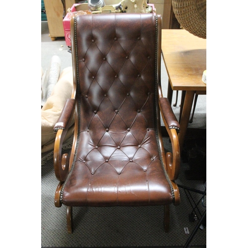 473 - A stunning red leather button back armchair.